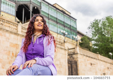 Latin woman cheerful and happiness portrait in front of Casa Lis in Salamanca. Heritage tourism. 104883755