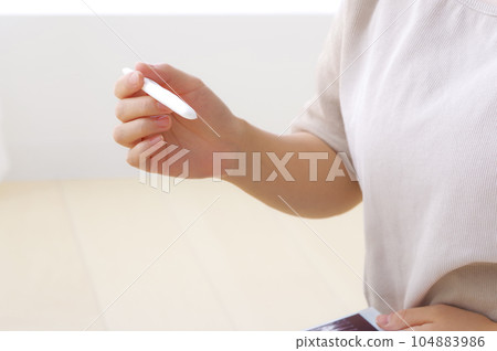 A woman doing a self-check for pregnancy A woman doing a self-check for pregnancy 104883986