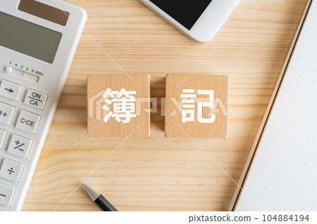 Bookkeeping block, calculator, smartphone, notebook, pen Bookkeeping block, calculator, smartphone, notebook, pen 104884194