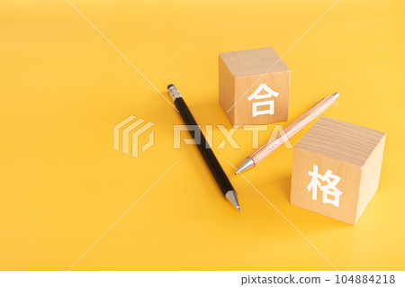 A building block and a pen that says "passed" A building block and a pen that says "passed" 104884218