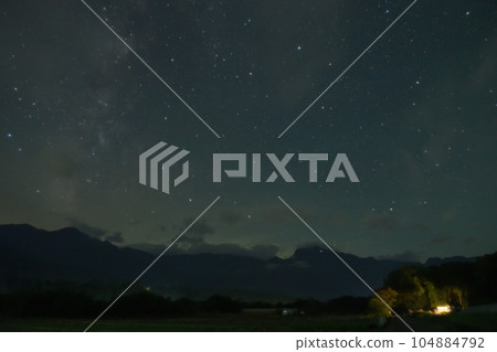 The Milky Way rising from the mountains of the Southern Alps in Takekawa-cho, Hokuto City and the stars in the western sky 104884792