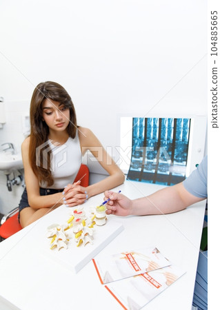 Medical consultation, spinal X-ray, Medical examination, Doctor's visit, Healthcare consultation, Consultation for spinal radiography,examining patients xray result 104885665