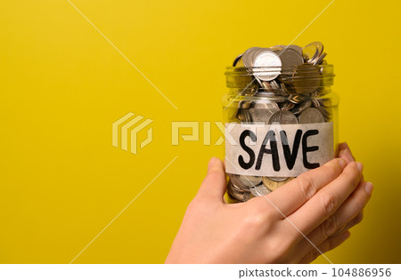 Hand holding coins in glass jar, Financial business investment, Growing money, People saving money, Money for future, Money saving concept Hand holding coins in glass jar, Financial business investment, Growing money, People saving money, Money for future, Money saving concept 104886956