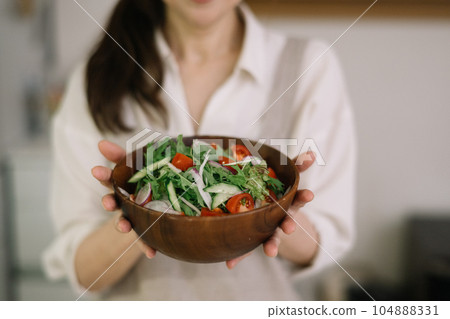 woman with a bowl of salad woman with a bowl of salad 104888331