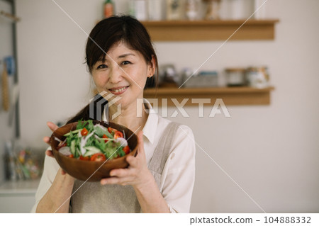 woman with a bowl of salad woman with a bowl of salad 104888332