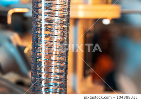 Close up of a plastic corrugated hosepipe in industrial factory Close up of a plastic corrugated hosepipe in industrial factory 104889313