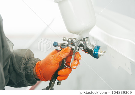 Airbrush paint gun in paint in car service station Airbrush paint gun in paint in car service station 104889369