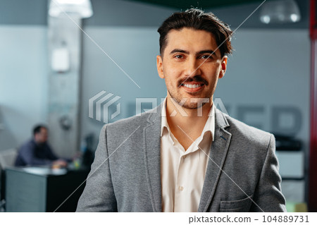 Confident Arab businessman in formal clothes standing in office 104889731