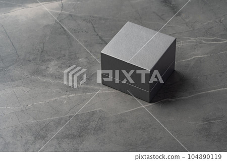Small jewelry box on gray background close up Small jewelry box on gray background close up 104890119