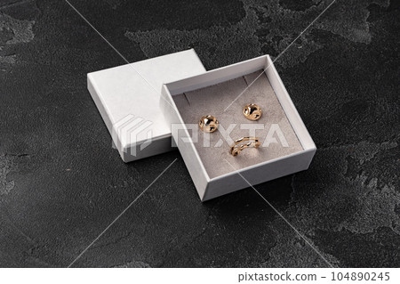 Jewelry box with earrings on a gray background 104890245