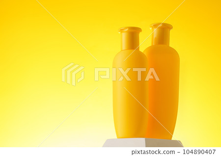 Cosmetic bottle with sunscreen lotion on yellow background 104890407