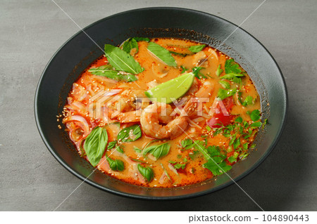 Tom Yum spicy Thai soup on gray background Tom Yum spicy Thai soup on gray background 104890443