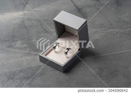 Jewelry box with earrings on a gray background Jewelry box with earrings on a gray background 104890642