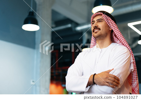 Successful muslim businessmen in traditional outfit in his office Successful muslim businessmen in traditional outfit in his office 104891027