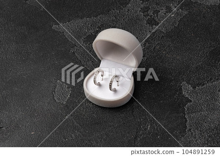 Jewelry box with earrings on a gray background 104891259