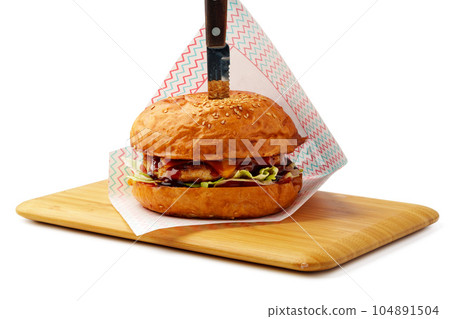 Delicious burger on wooden board isolated on white background 104891504