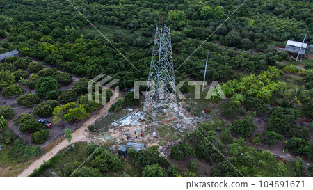 Architectural metal structures of frame base connection with rivets and reinforced metal structures. Assemble and install Steel Tower for power transmission lines for sustainable power development. 104891671