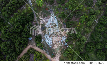 Architectural metal structures of frame base connection with rivets and reinforced metal structures. Assemble and install Steel Tower for power transmission lines for sustainable power development. 104891672