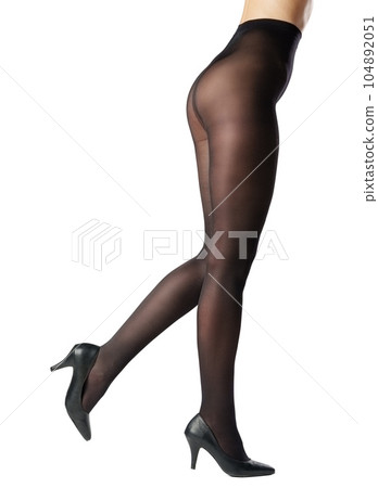 Legs of a woman in black capron tights on white background Legs of a woman in black capron tights on white background 104892051