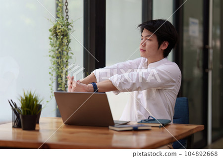 Businessman in office relaxing in chair. Resting with thoughtful mind thinking of life quality 104892668