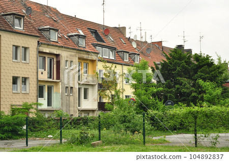Old family house with demolished balconies and weathered walls in Ruhr area, Essen, Germany 104892837