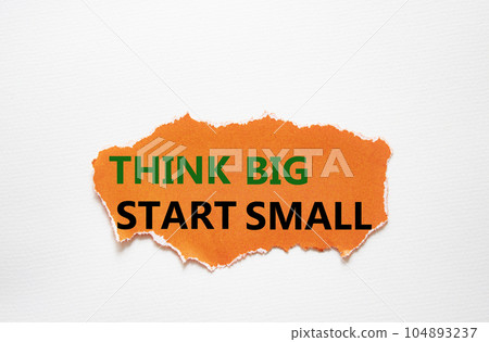Think big start small symbol. Concept words Think big start small on torn oarnge paper. Beautiful white background. Business and Think big start small concept. Copy space Think big start small symbol. Concept words Think big start small on torn oarnge paper. Beautiful white background. Business and Think big start small concept. Copy space 104893237