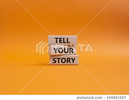 Tell your story symbol. Wooden blocks with words Tell your story. Beautiful orange background. Business and Tell your story concept. Copy space. 104893307