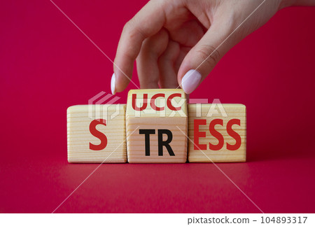 Success vs Stress symbol. Businessman hand turns wooden cubes and changes the word Stress to Success. Beautiful red background. Business concept and Success vs Stress. Copy space Success vs Stress symbol. Businessman hand turns wooden cubes and changes the word Stress to Success. Beautiful red background. Business concept and Success vs Stress. Copy space 104893317