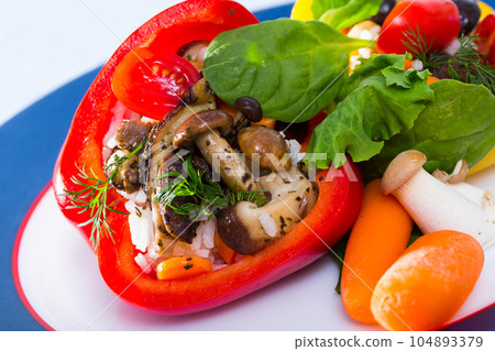 Peppers stuffed with wild mushrooms, rice, herbs, vegetables 104893379