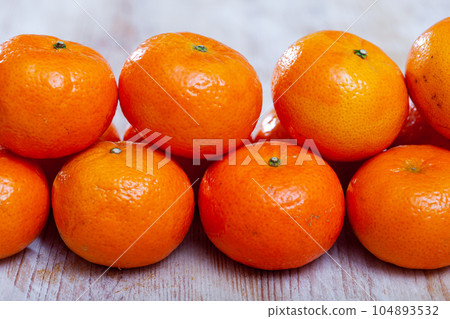 Closeup of fresh sweet clementines on wooden table 104893532