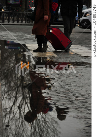 Reflection of a woman in a puddle. Metro, Paris, France 104893749