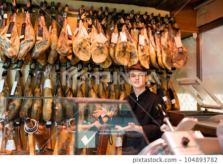 Owner of butcher shop selling traditional spanish jamon Owner of butcher shop selling traditional spanish jamon 104893782
