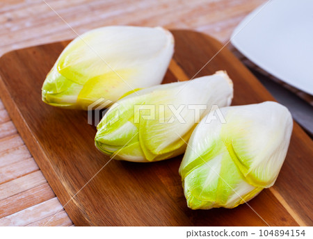 Vegetarian food before cooking, raw endive Vegetarian food before cooking, raw endive 104894154