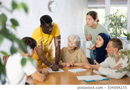 African american man conducting informal meeting with colleagues 104894235