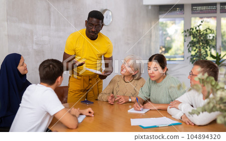 African american man conducting informal meeting with colleagues 104894320