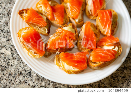 Sandwiches of fresh baguette with smoked salmon and butter Sandwiches of fresh baguette with smoked salmon and butter 104894499