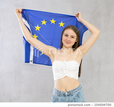 Young woman with EU flag posing in studio Young woman with EU flag posing in studio 104894700