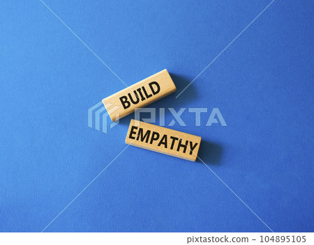 Build empathy symbol. Wooden blocks with words Build empathy. Beautiful blue background. Psychology and Build empathy concept. Copy space. Build empathy symbol. Wooden blocks with words Build empathy. Beautiful blue background. Psychology and Build empathy concept. Copy space. 104895105