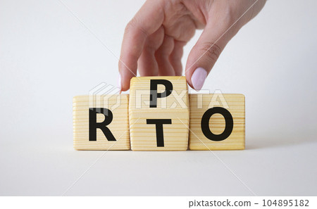 RPO vs RTO symbol. Businessman hand turns wooden cubes and changes the word RTO to RPO. Beautiful white background. business concept. Copy space 104895182