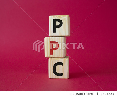 PPC - Pay Per Click symbol. Wooden cubes with words PPC. Beautiful red background. Business and PPC concept. Copy space. 104895235
