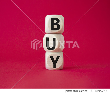 BUY symbol. Concept word BUY on wooden blocks. Beautiful red background. Business and BUY concept. Copy space 104895255