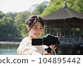 Kimono woman taking a V-log selfie at a tourist spot 104895442