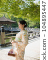 A kimono woman standing in a fresh green tourist spot 104895447