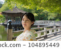 A kimono woman standing in a fresh green tourist spot 104895449