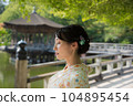 A kimono woman standing in a fresh green tourist spot 104895454