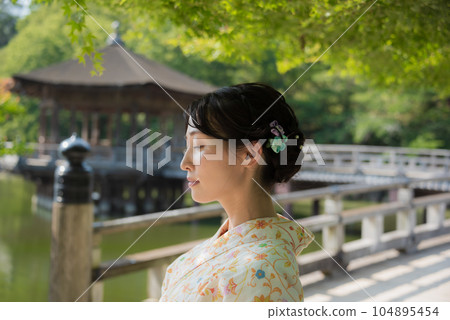 A kimono woman standing in a fresh green tourist spot 104895454