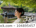 A kimono woman standing in a fresh green tourist spot 104895457