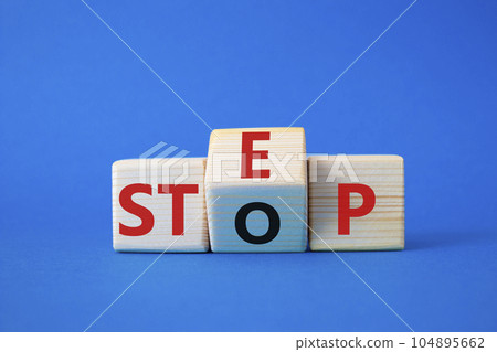 Step vs Stop symbol. Wooden cubes with words Stop and Step. Beautiful blue background. Step vs Stop and business concept. Copy space Step vs Stop symbol. Wooden cubes with words Stop and Step. Beautiful blue background. Step vs Stop and business concept. Copy space 104895662
