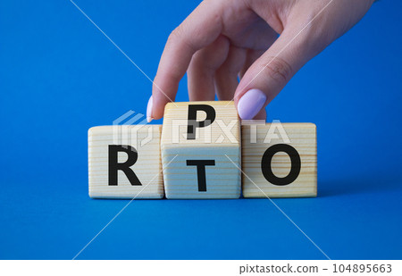 RPO vs RTO symbol. Businessman hand turns wooden cubes and changes the word RTO to RPO. Beautiful blue background. business concept. Copy space 104895663
