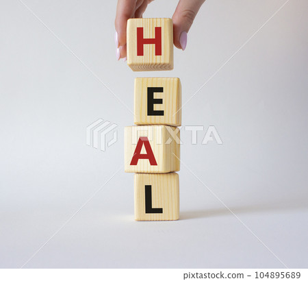 Heal symbol. Concept word Hate on wooden cubes. Doctor Heal. Beautiful white background. Healthcare and Heal concept. Copy space. 104895689